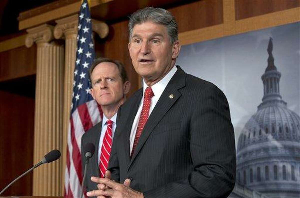 FILE - In this April 10, 2013 file photo, Sen. Joe Manchin, D-W.Va., right, accompanied by Sen. Patrick Toomey, R-Pa., announce that they have reached a bipartisan deal on expanding background checks to more gun buyers,, on Capitol Hill in Washington. The number of Republican senators who might back expanded background checks is now dwindling, threatening a bipartisan effort to subject more gun buyers to the checks. A vote on the compromise, the heart of Congress' gun control effort, is expected this week. (AP Photo/J. Scott Applewhite, File)