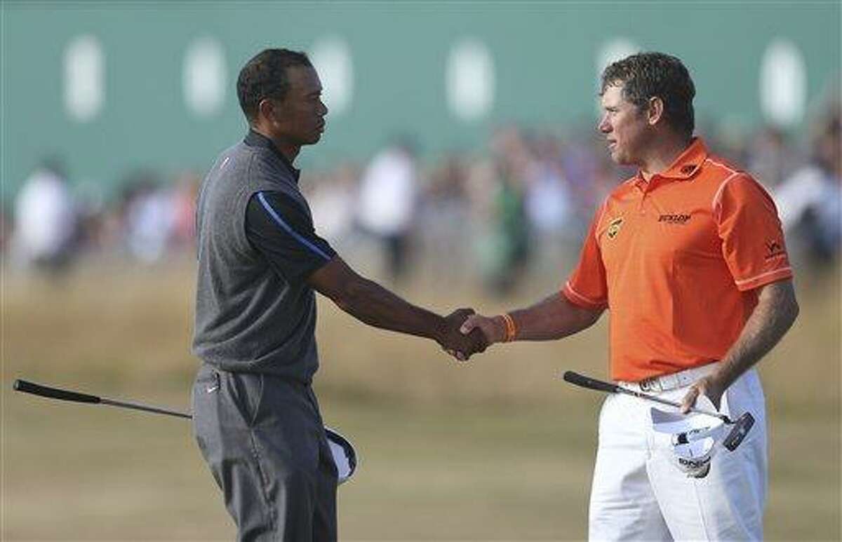 Tiger Woods of the United States, left, shakes hands with Lee Westwood of England on the 18th green after their third round of the British Open Golf Championship at Muirfield, Scotland, Saturday July 20, 2013. (AP Photo/Scott Heppell)