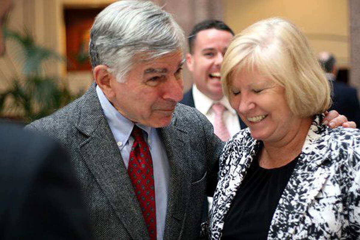 Former presidential candidate and Mass. Gov. Michael Dukakis jokes with state Rep. Ellen O’Brien, who died overnight.