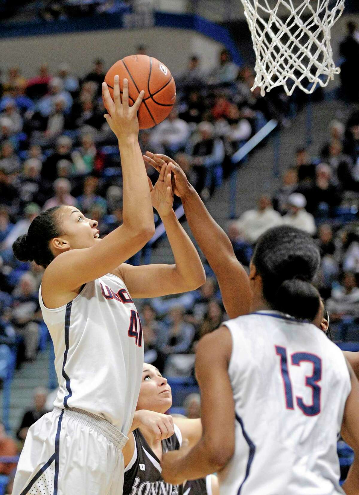 UConn’s Kiah Stokes (41) scores two of her 19 points as teammate Brianna Banks (13) and St. Bonaventure’s Kelcie Rombach, center, stand by during the first half Sunday.