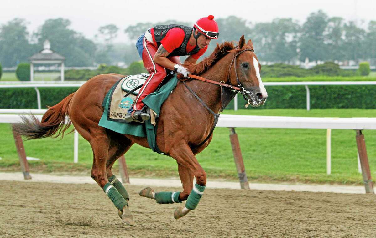 Exercise rider Willie Delgado gallops California Chrome on a second lap during a workout at Belmont Park on Wednesday in New York. The Kentucky Derby and Preakness Stakes winner will attempt to become the first Triple Crown winner since Affirmed in 1978 when he races in the 146th running of the Belmont Stakes on Saturday.
