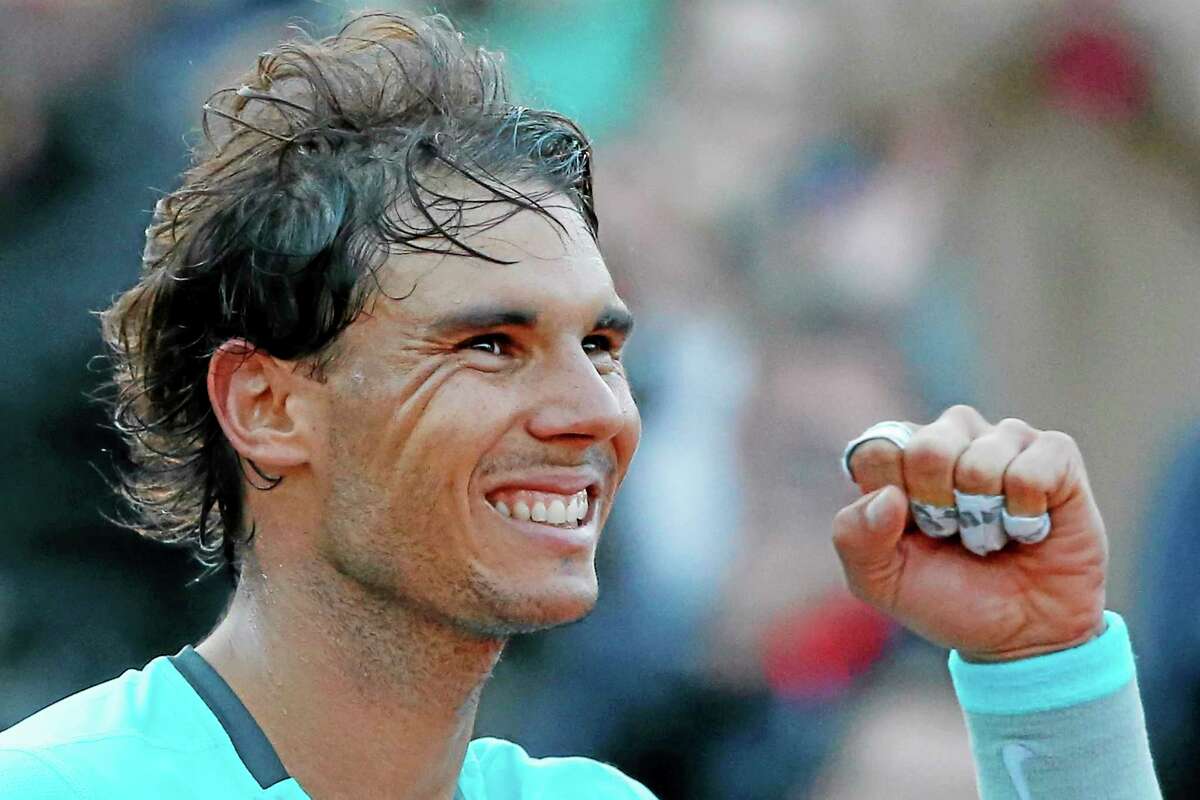 Rafael Nadal celebrates winning the quarterfinal match of the French Open against David Ferrer on Wednesday at the Roland Garros stadium in Paris. Nadal won 4-6, 6-4, 6-0, 6-1.