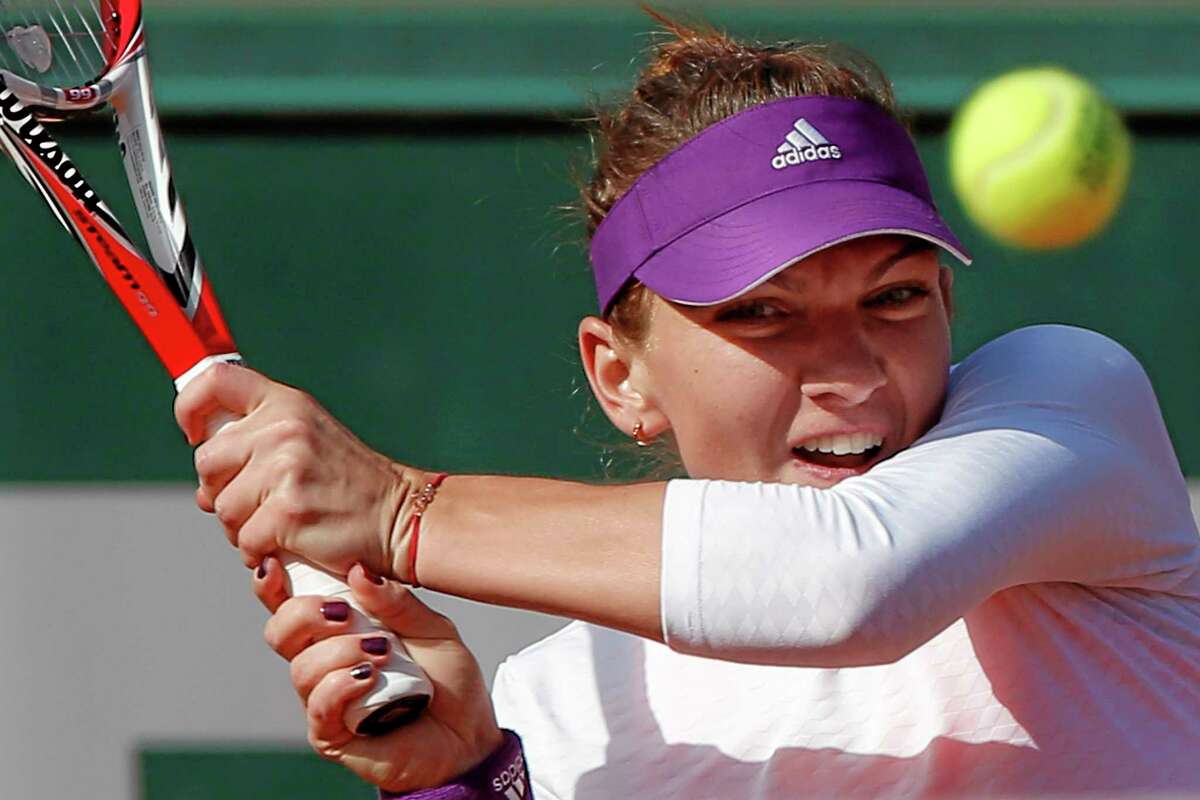 Defending New Haven Open champion Simona Halep returns the ball during the quarterfinals of the French Open against Svetlana Kuznetsova Wednesday at the Roland Garros stadium in Paris. Halep won 6-2, 6-2.