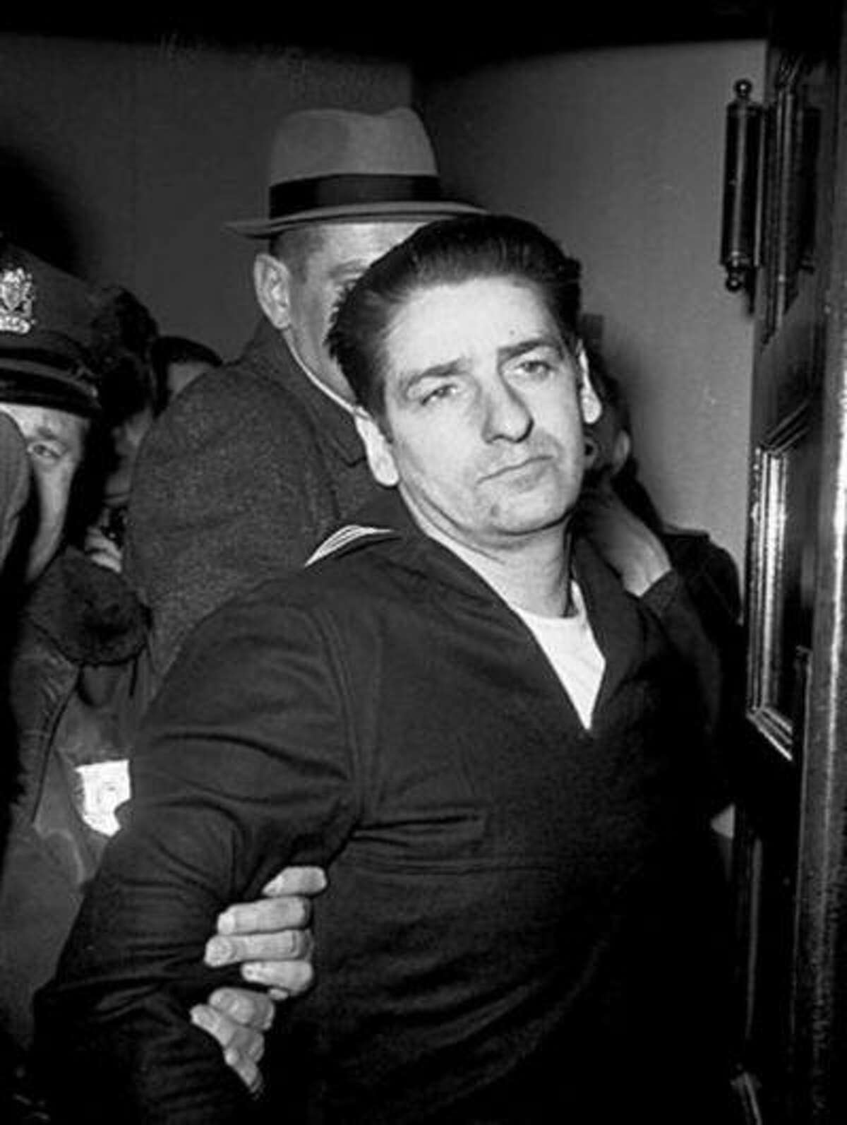 FILE - This Feb. 25, 1967, file photo shows self-confessed Boston Strangler Albert DeSalvo minutes after his capture in Boston. DeSalvo confessed to the string of 1960s killings but was never convicted. He died in prison in the 1970s. Massachusetts officials said Thursday, July 11, 2013, that DNA technology led to a breakthrough, putting them in a position to formally charge the Boston Strangler with the murder of Mary Sullivan, last of the slayings attributed to the Boston Strangler. (AP Photo, File)