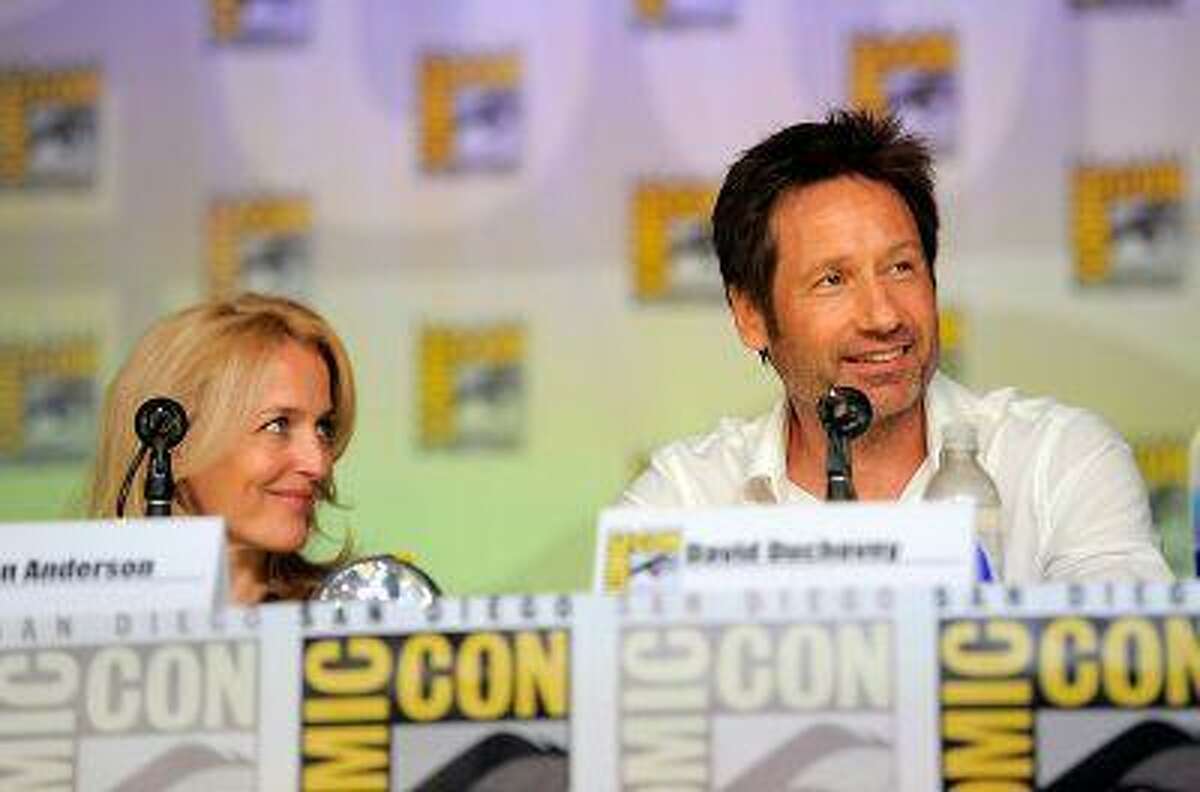 Gillian Anderson, left, and David Duchovny attend the "The X Files" 20th Anniversary panel on Day 2 of Comic-Con International on Thursday, July 18, 2013 in San Diego, Calif. (Photo by Chris Pizzello/Invision/AP)