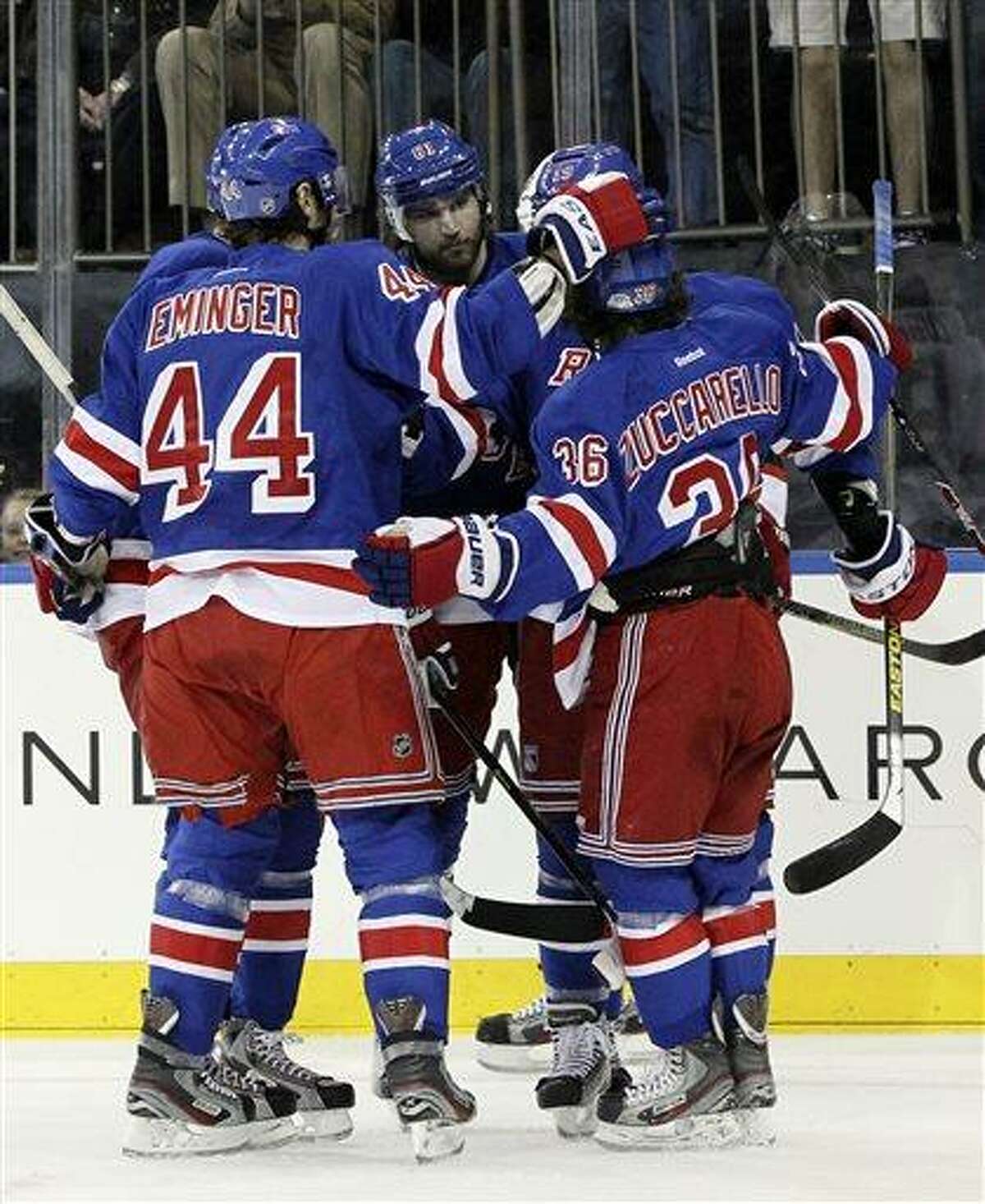 New York Rangers' Rick Nash, center, celebrates with his teammates after scoring a goal during the second period of an NHL hockey game against the New Jersey Devils, Saturday, April 27, 2013 at Madison Square Garden in New York. The Rangers won 4-0. (AP Photo/Mary Altaffer)