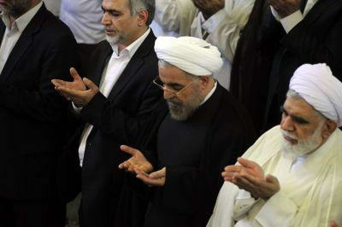 Iranian president-elect Hassan Rowhani attends the weekly Friday prayer with Shiite Muslim worshippers during the Muslim fasting month of Ramadan on July 12, 2013 at the university of the Iranian capital, Tehran.