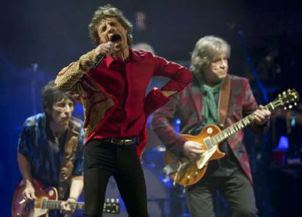 n this June 29, 2013 file photo Mick Jagger, center, Ronnie Wood, left, and Mick Taylor, of British rock band The Rolling Stones, perform on the Pyramid main stage at Glastonbury, England.