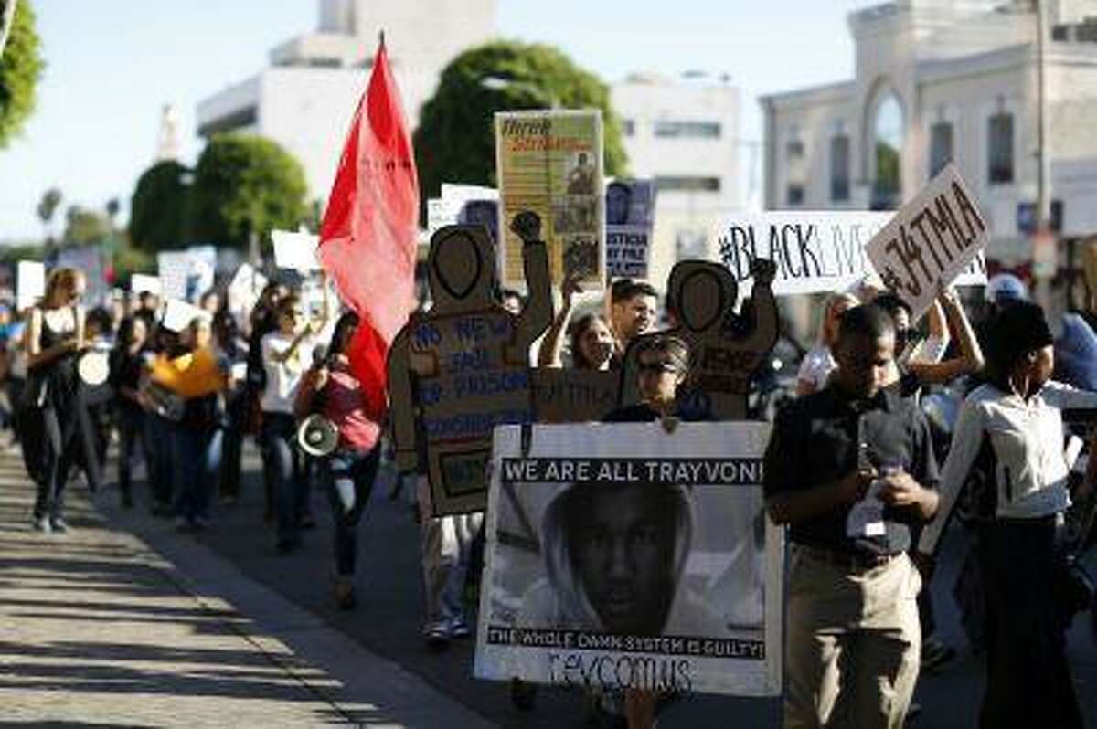Demonstrators march to protest the acquittal of George Zimmerman in the killing of Florida teen Trayvon Martin in Beverly Hills, California July 17, 2013.