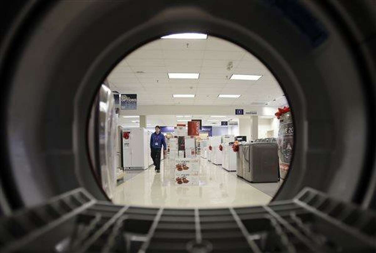 FILE - In this Dec. 6, 2012, photo, an employee walks through the appliance department at a Sears in North Olmsted, Ohio. The U.S. economy grew at a slightly faster but still anemic rate at the end of last year. However, there is hope that growth accelerated in early 2013 despite higher taxes and cuts in government spending. (AP Photo/Mark Duncan, File)