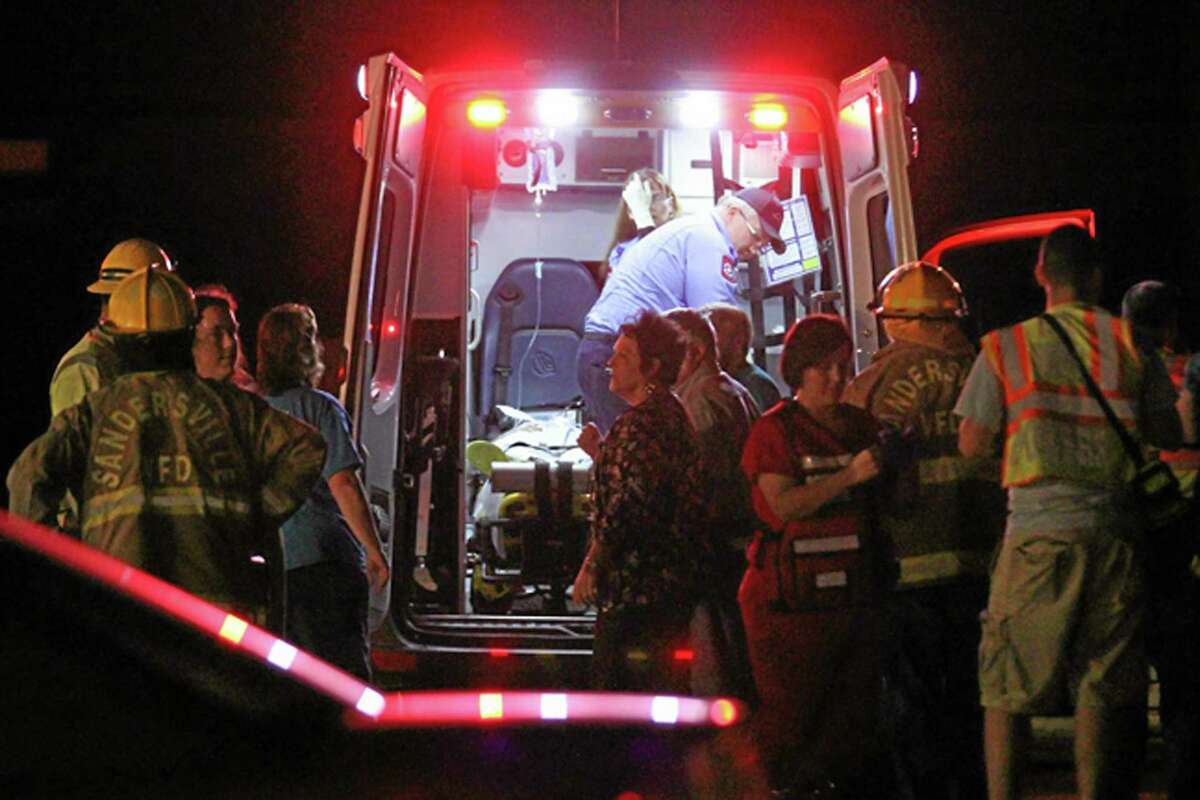 Emergency responders, members of Freedom Baptist Church, and Myrick community members in rural Jones County, Miss. gather near an ambulance outside the Freedom Baptist Church Wednesday night after a second floor youth room collapsed onto a first floor kitchen. Up to 35 youth ages from seventh grade to 12th grade were injured. A 16-year-old girl who suffered a head injury was airlifted to Forrest General Hospital in Hattiesburg. AP Photo/The Chronicle, James Pugh