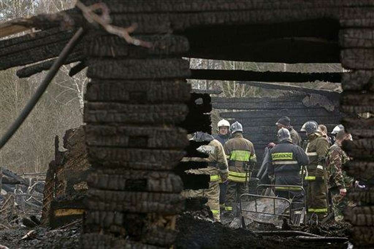 Ministry for Emergency Situations workers and fire fighters work at the site of a fire at a psychiatric hospital Friday morning, April 26, 2013. A fire raged through a psychiatric hospital outside Moscow early Friday, killing 38 people, including two nurses, emergency officials said. Police said the fire, which broke out at about 2 a.m. local time (7 p.m. Eastern, 2300 GMT) in the one-story hospital in the Ramenskoye settlement, was caused by a short circuit. (AP Photo/Pavel Sergeyev)
