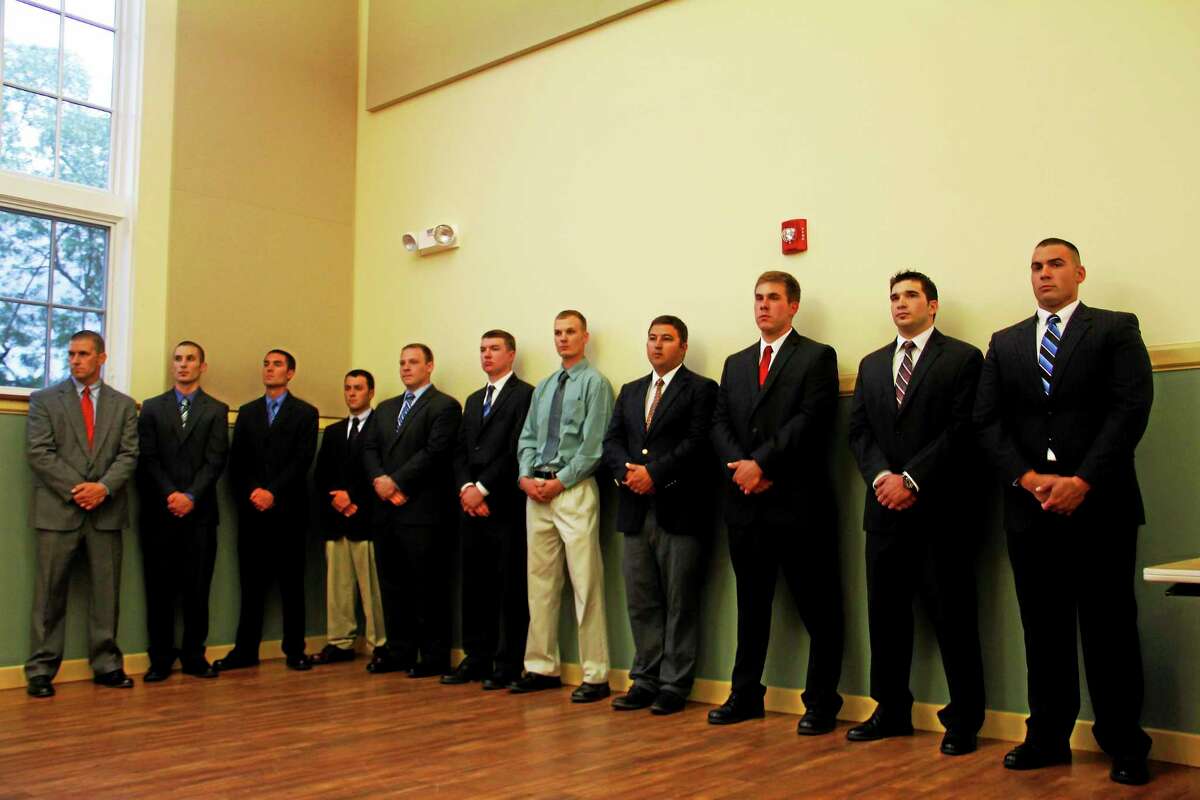 Members of the Torrington Fire Department’s new recruiting class stand inside the City Hall Auditorium on Wednesday.