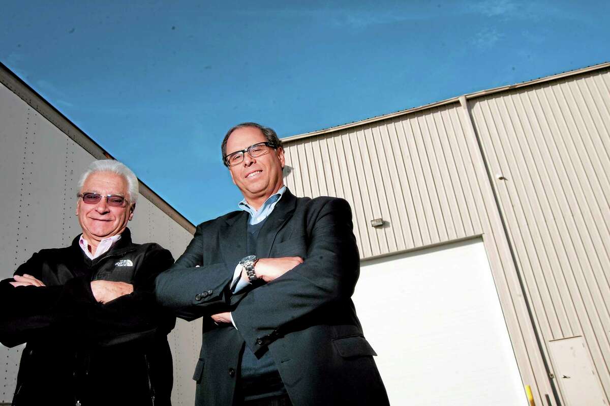 H. Krevit & Co. Vice President of Operations Don DeChello and President and CEO Thomas Ross stand in front of a new building the company will use as part of its switch to “greener” production.