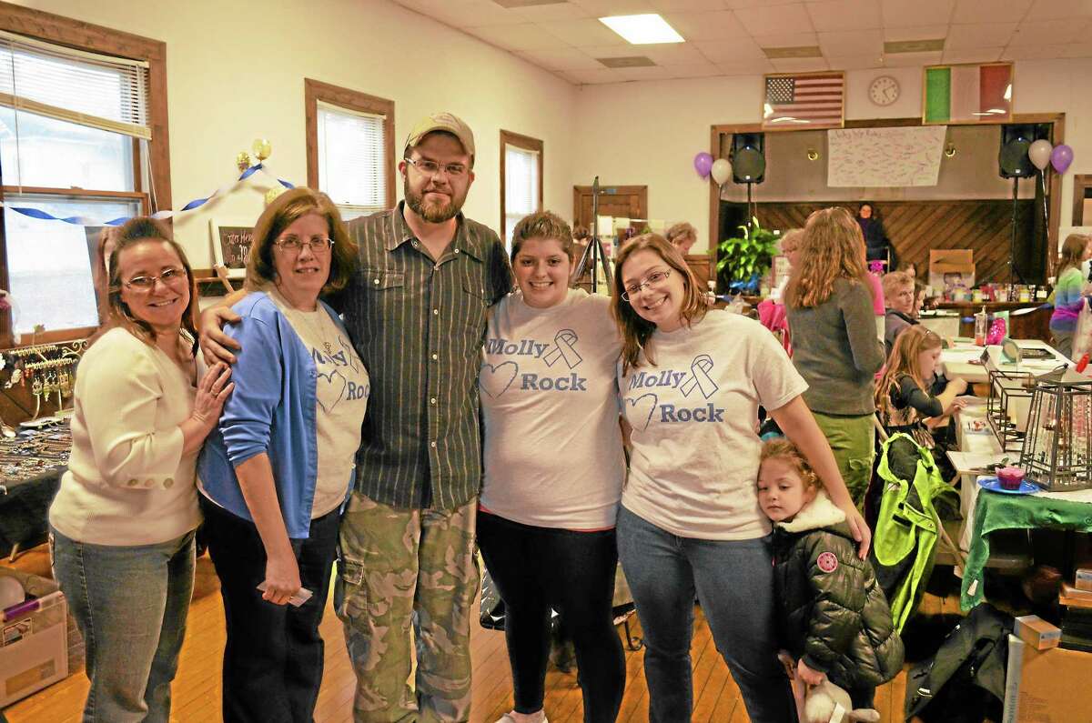 Suzy and Gabby Finello and Denise Tucker, pictured with their family, hosted a vendor sale to raise money for their Relay for Life team MollyRock.