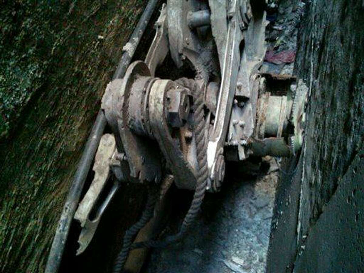This Friday, April 26, 2013, photo provided by the New York City Police Department shows a piece of landing gear that authorities believe belongs to one of the airliners that crashed into the World Trade Center on Sept. 11, 2001, that was found wedged between a mosque and another building, in New York. Police say the medical examiner's office will complete a health and safety evaluation to determine whether to sift the soil around the buildings for possible human remains. (AP Photo/New York City Police Department)