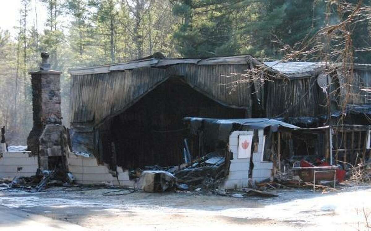 The fire scorched remains of the Norfolk Curling Club. Register Citizen photo.