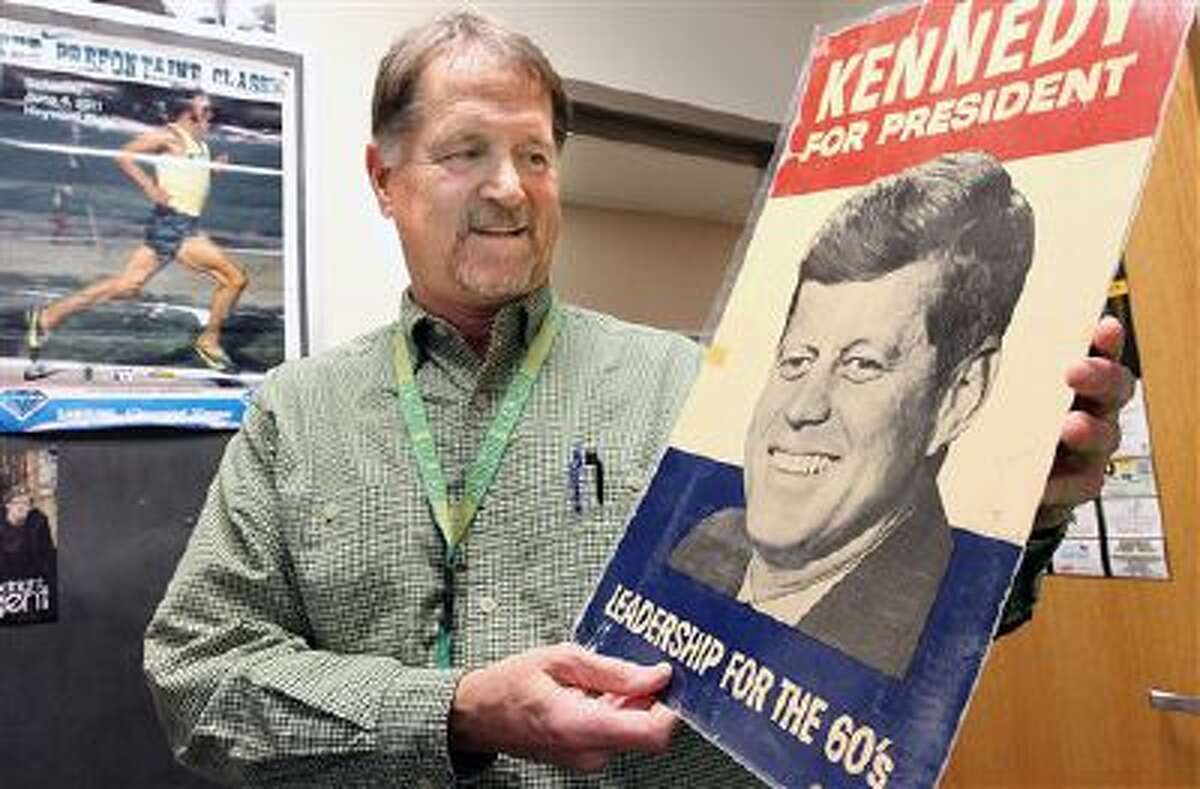 Jim Qualheim holds a copy of President John F. Kennedy's 1960 campaign-for-president sign he received when he was 12 years old while going door to door spreading leaflets with his family.