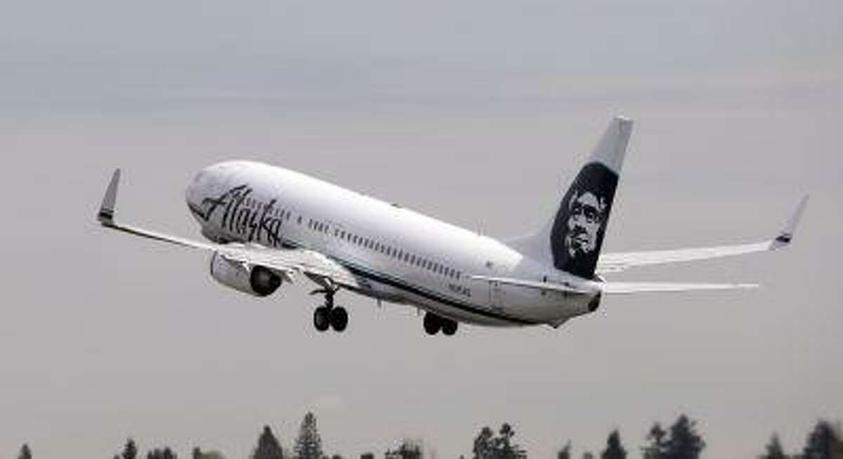 An Alaska Airline jet takes off at Seattle-Tacoma International Airport Tuesday, April 23, 2013, in Seattle. (AP Photo/Elaine Thompson)