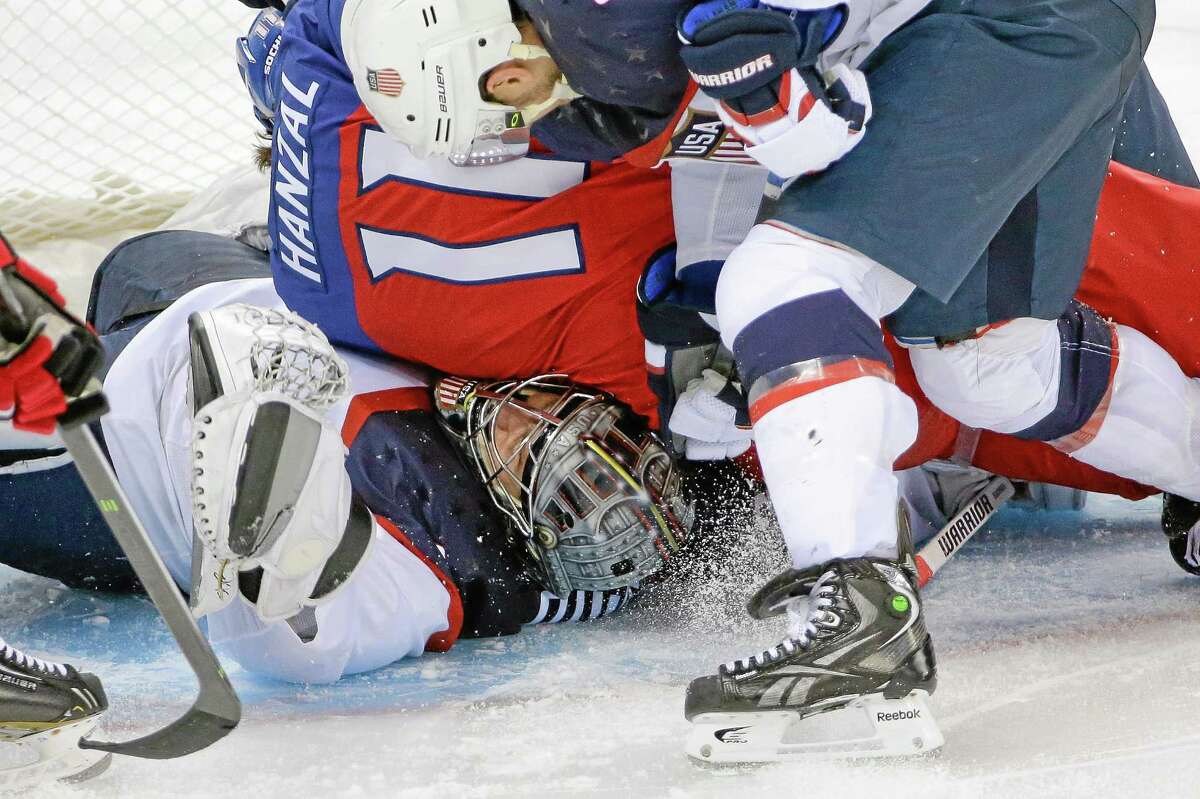USA goaltender Jonathan Quick of Hamden is crushed under Czech Republic forward Martin Hanzal during the third period of the United States’ 5-2 win over the Czech Republic in Shayba Arena on Wednesday at the Winter Olympics in Sochi, Russia.