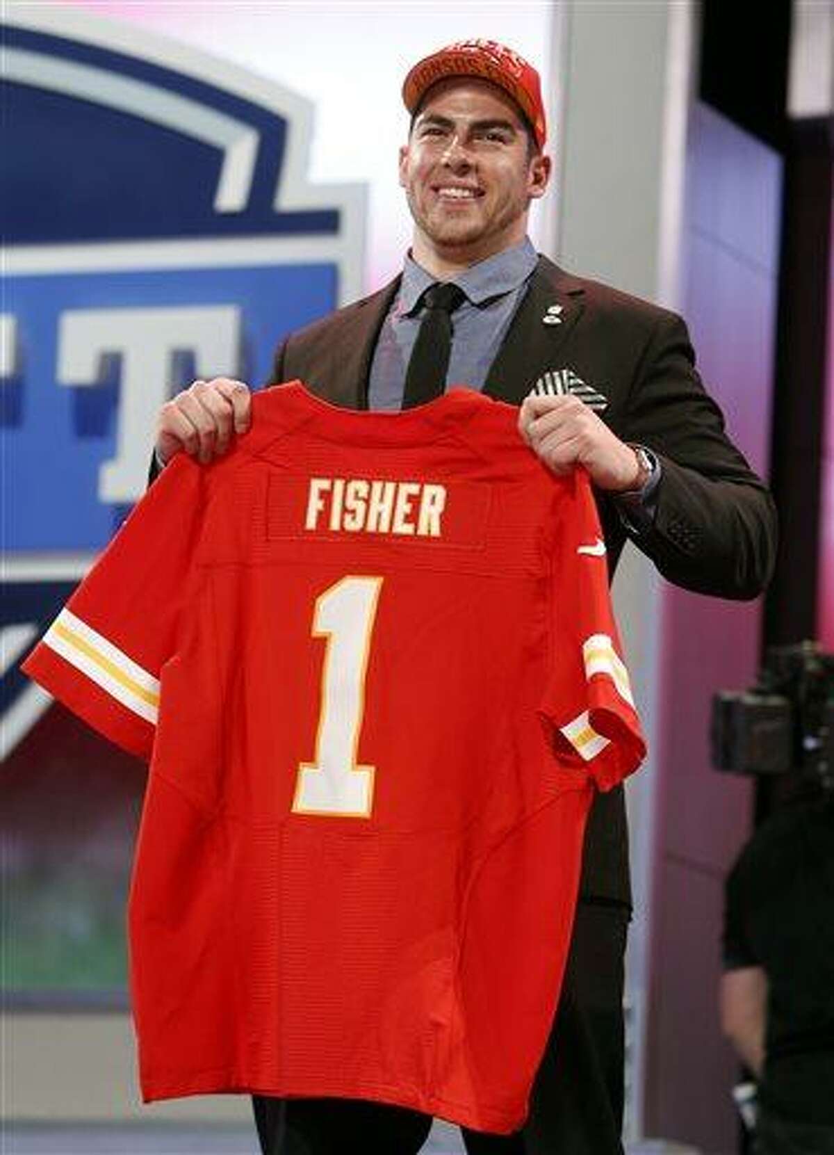 Tackle Eric Fisher from Central Michigan holds up the team jersey after being selected first overall by the Kansas City Chiefs in the first round of the NFL football draft, Thursday, April 25, 2013 at Radio City Music Hall in New York. (AP Photo/Jason DeCrow)