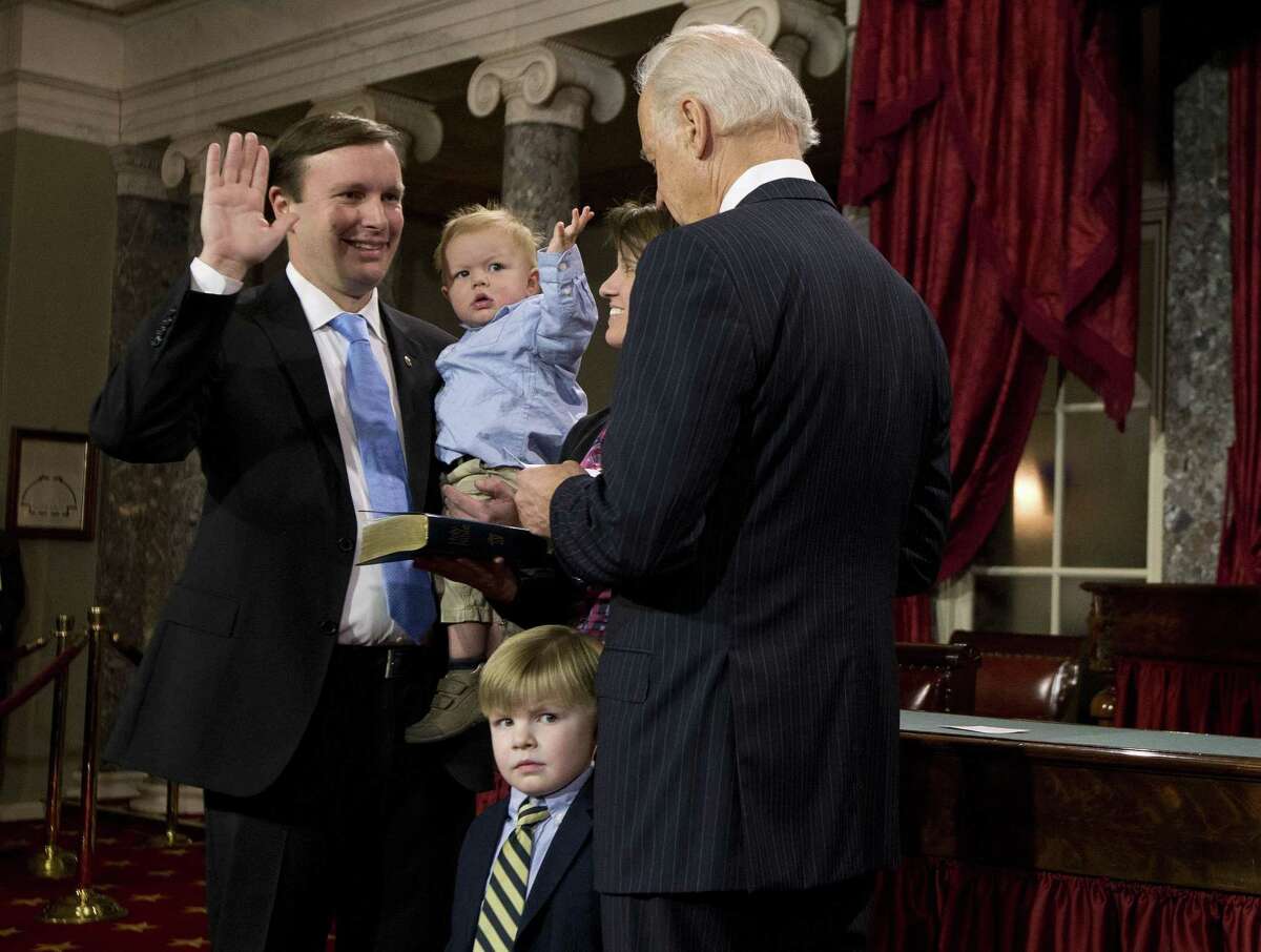 Vice President Joe Biden administers the Senate Oath to Sen. Chris Murphy, D-Conn., accompanied by his wife Catherine and sons Rider and Owen, right, during a mock swearing in ceremony on Capitol Hill in Washington, Thursday, Jan. 3, 2013, as the 113th Congress officially began. (AP Photo/ Evan Vucci)