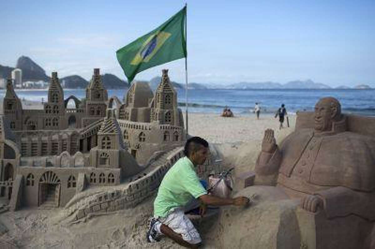 Artist Rogean Rodrigues builds a sand sculpture of Pope Francis in preparation for the pontiff's visit for World Youth Day events along Copacabana beach in Rio de Janeiro, Brazil, July 16.