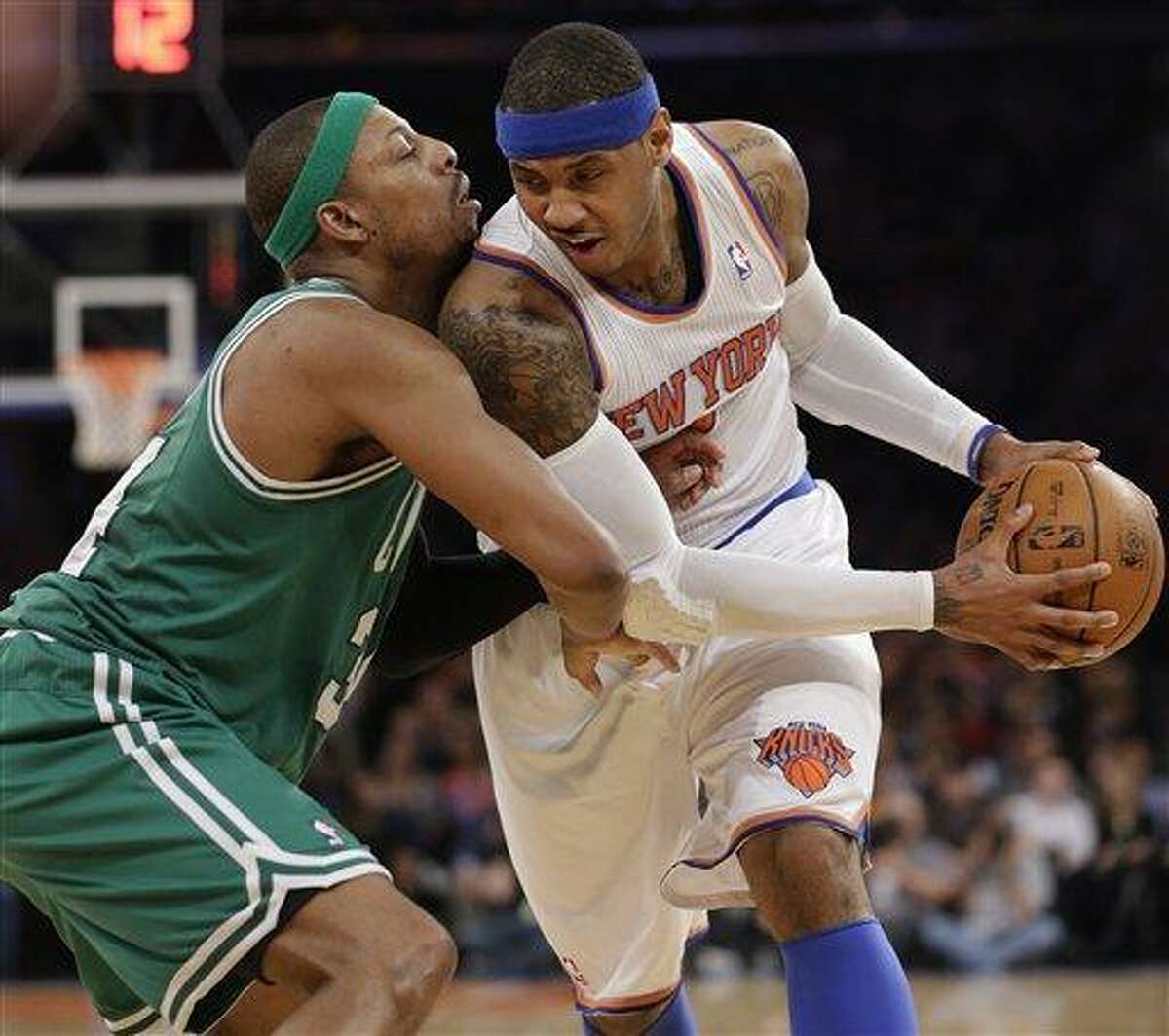 Boston Celtics forward Paul Pierce (34) defends as New York Knicks forward Carmelo Anthony (7) tries to drive around him in the first half of Game 2 of their first-round NBA basketball playoff series in New York, Tuesday, April 23, 2013. The Knicks went up 2-0 in the series, defeating the Celtics 87-71. (AP Photo/Kathy Willens)