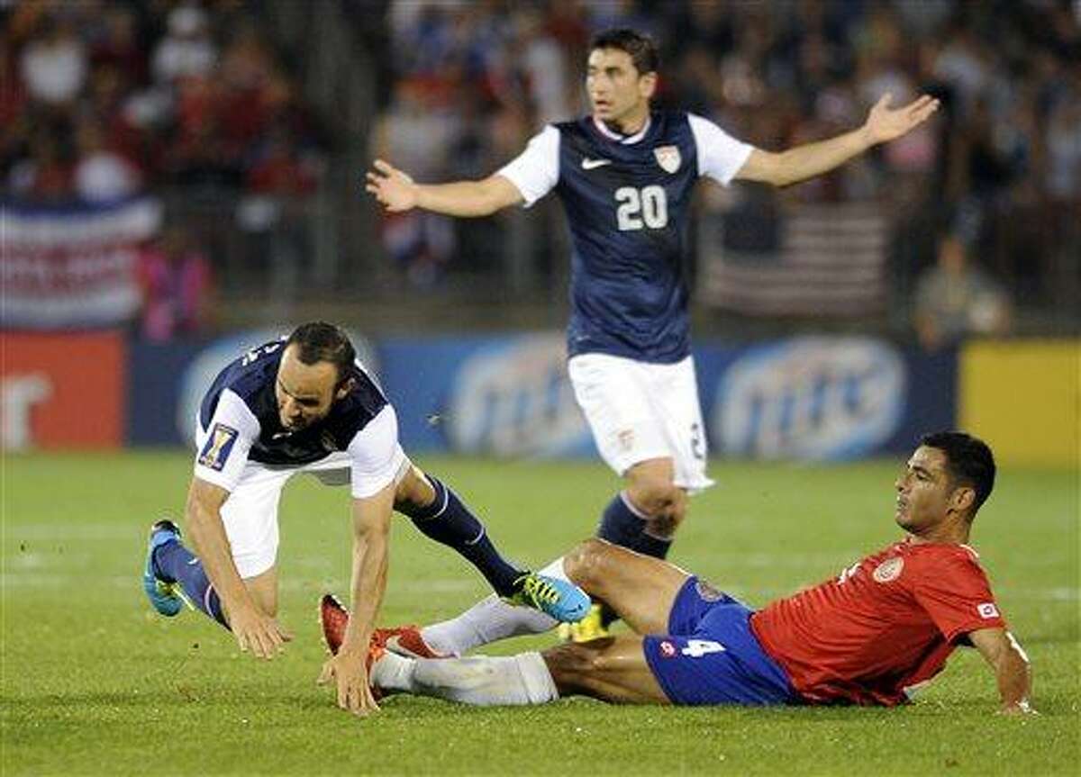United States' Landon Donovan, left, is fouled by Costa Rica's Michael Umana, right, in front of United States' Alejandro Bedoya during the second half of a CONCACAF Gold Cup soccer match Tuesday, July 16, 2013, in East Hartford, Conn. The U.S. team won 1-0. (AP Photo/Fred Beckham)