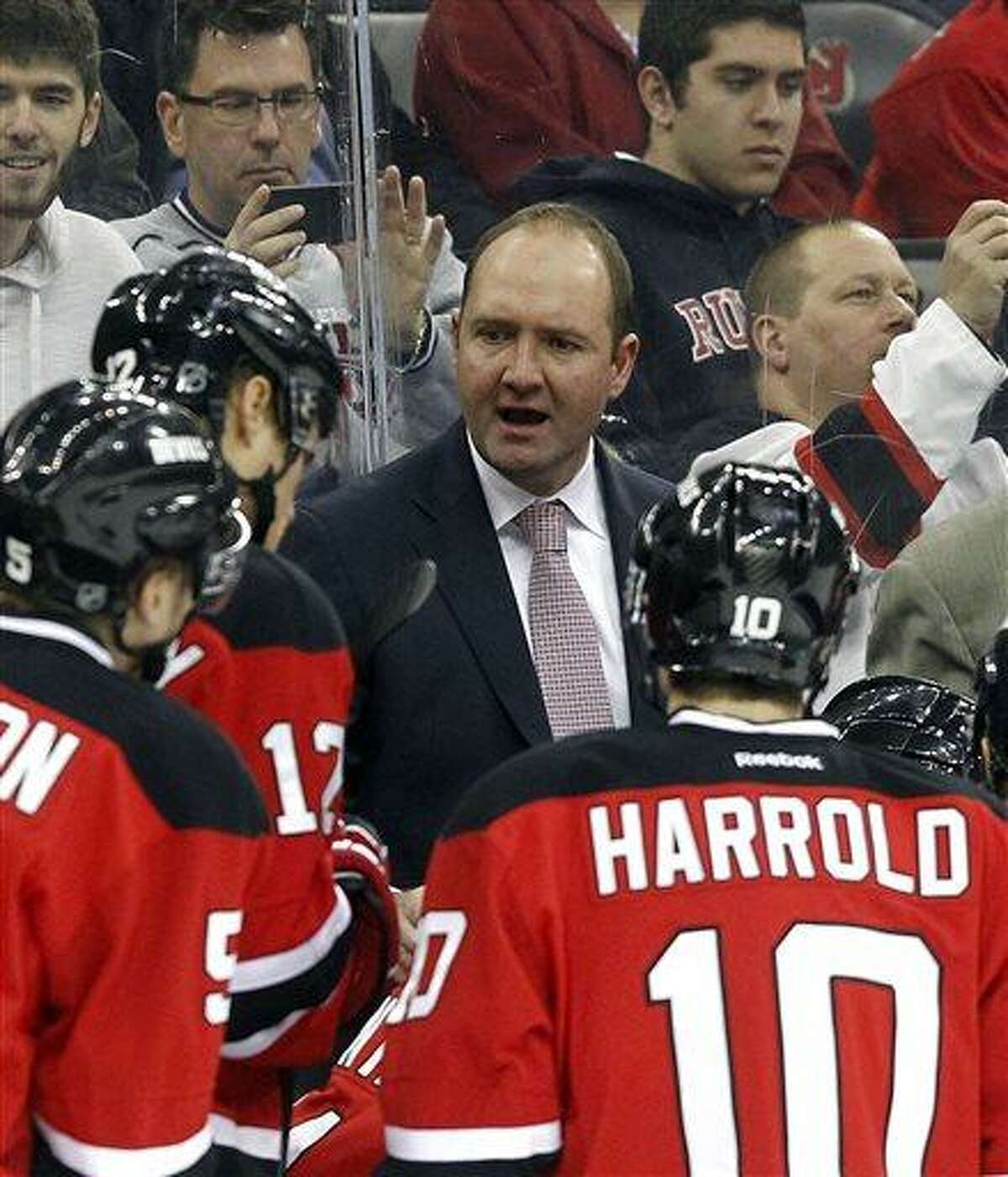 FILE - In this April 20, 2013 file photo, New Jersey Devils head coach Peter DeBoer talks to his team during the first period of an NHL hockey game against the Florida Panthers in Newark, N.J. While caught off guard by star forward Ilya Kovalchuk's decision to retire from the NHL and return home to Russia, New Jersey Devils coach DeBoer said his team's job next season is to play well enough to make up for the loss of one of the NHL's top players. (AP Photo/Jason DeCrow, File)
