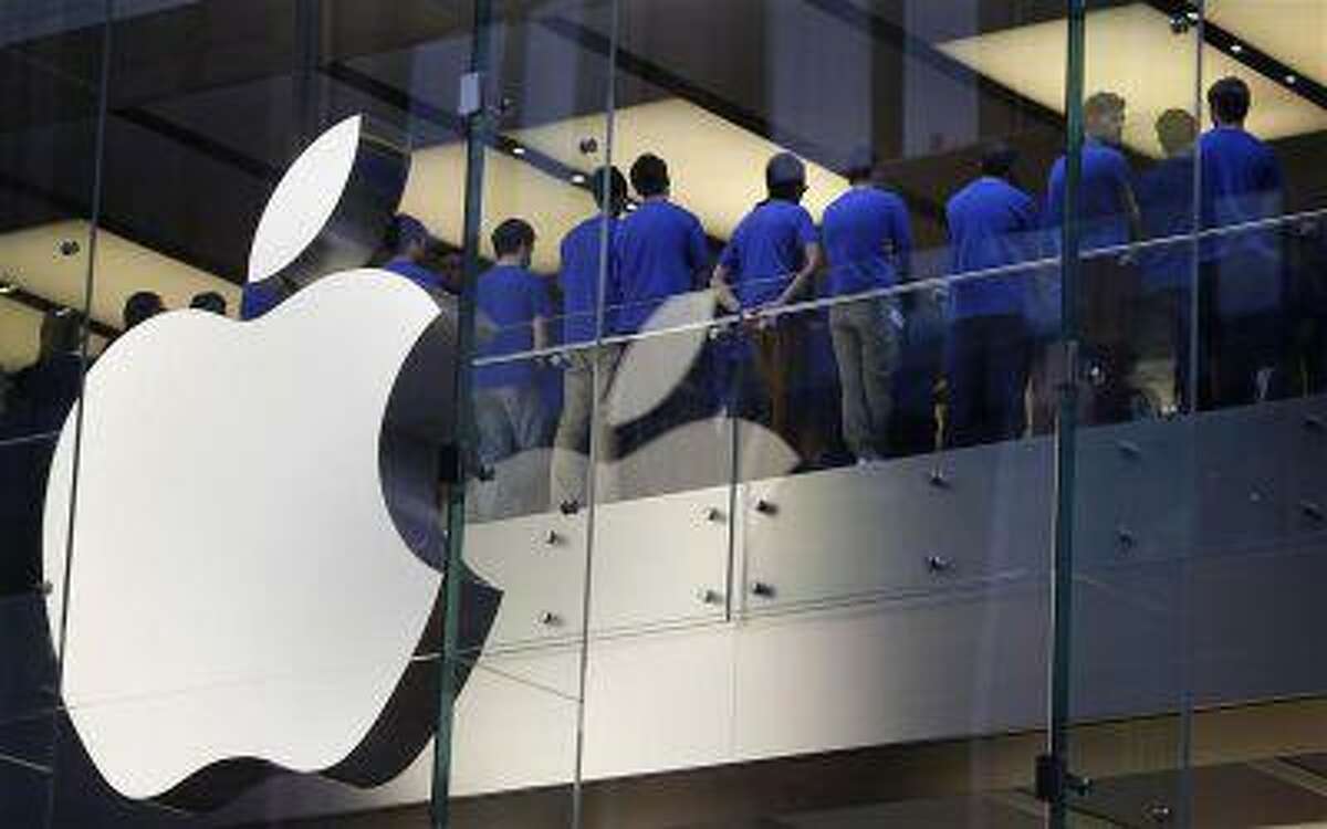 Staff at an Apple store hold a meeting before they open their doors on the day the iPhone 5 went on sale to the public, in central Sydney September 21, 2012.