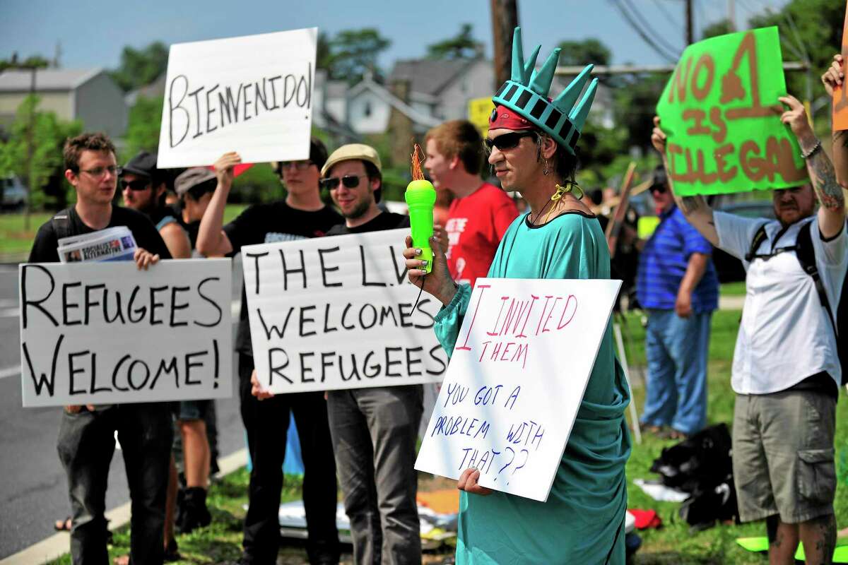 Members of the Industrial Workers of the World Lehigh Valley branch rally outside the KidsPeace Broadway campus in Sunday, July 27, 2014 in Fountain Hill, Pa. in support of the unaccompanied immigrant children who are temporarily housed there. (AP Photo/Chris Post)