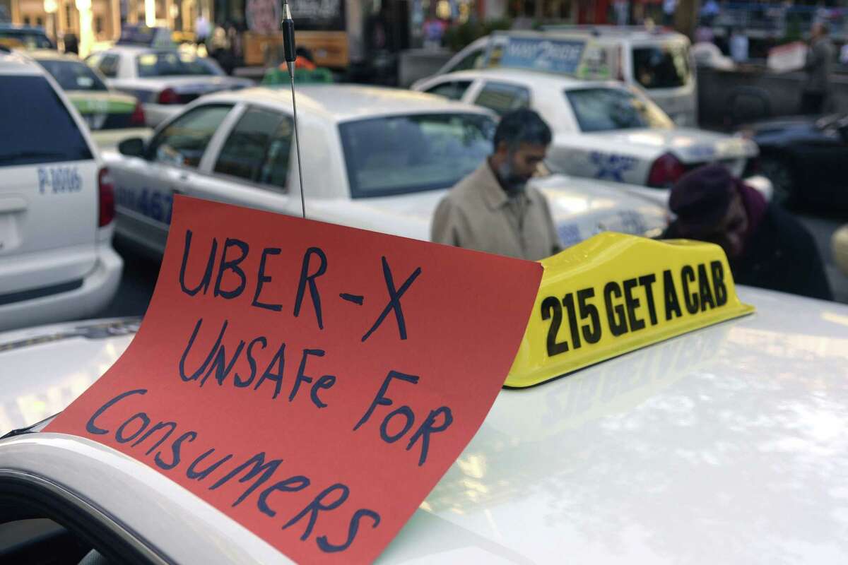 FILE PHOTO: Drivers with the Taxi Workers Alliance of Pennsylvania protest on near Love Park in Philadelphia Oct. 8, 2014, as Uber and Lyft are making a concerted push to bring their ride-share services to Philadelphia.