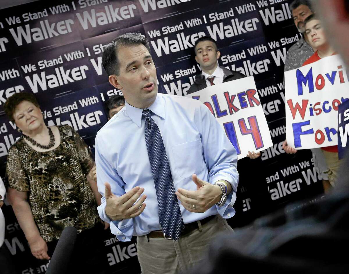 Wisconsin Gov. Scott Walker addresses members of the media and volunteers with the state's Republican Party during a stop at the Madison GOP field office in Madison, Wis., Wednesday, July 23, 2014. (AP Photo/Wisconsin State Journal, John Hart)