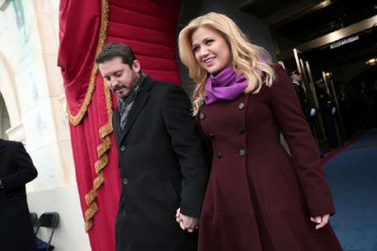 In this Jan. 21, 2013 photo, singer Kelly Clarkson and Brandon Blackstock arrive on the West Front of the Capitol in Washington.