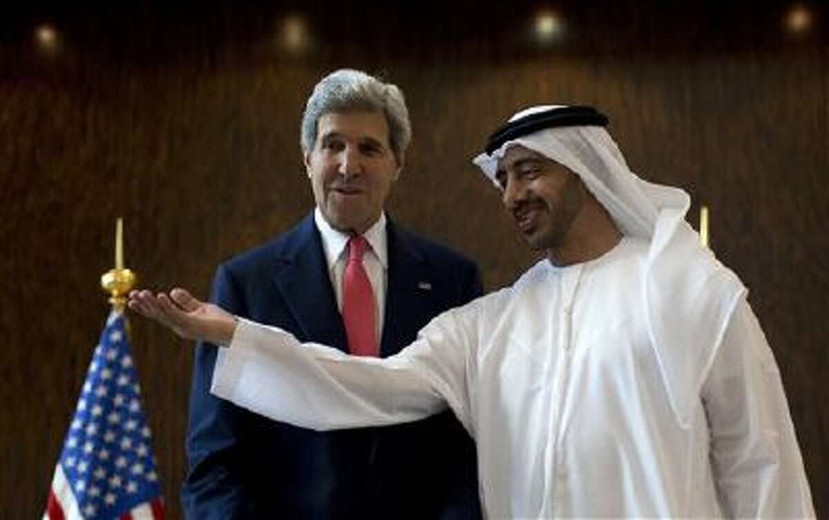 U.S. Secretary of State John Kerry, left, is welcomed Nov. 11 by United Arab Emirates Foreign Minister Abdullah bin Zayed Al-Nahyan at the foreign ministry in Abu Dhabi.