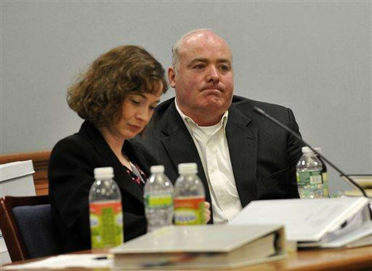 Defense attorney Jessica Santos, left, and Michael Skakel listen to testimony of author Leonard Levitt at Skakel's habeas corpus trial at Rockville Superior Court in Vernon, Conn., on Monday, April 22, 2013. Levitt is the author of the book, "Solving the Moxley Murder: A Reporter and Detective's Twenty-Year Search for Justice." (AP Photo/The Stamford Advocate, Jason Rearick, Pool)