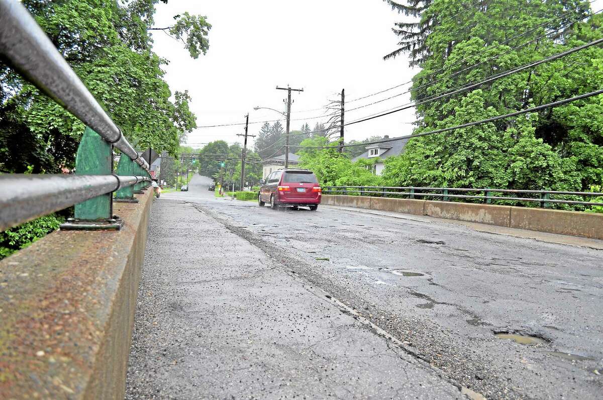 A car drives over Winsted’s Holabird Avenue bridge in June 2013.