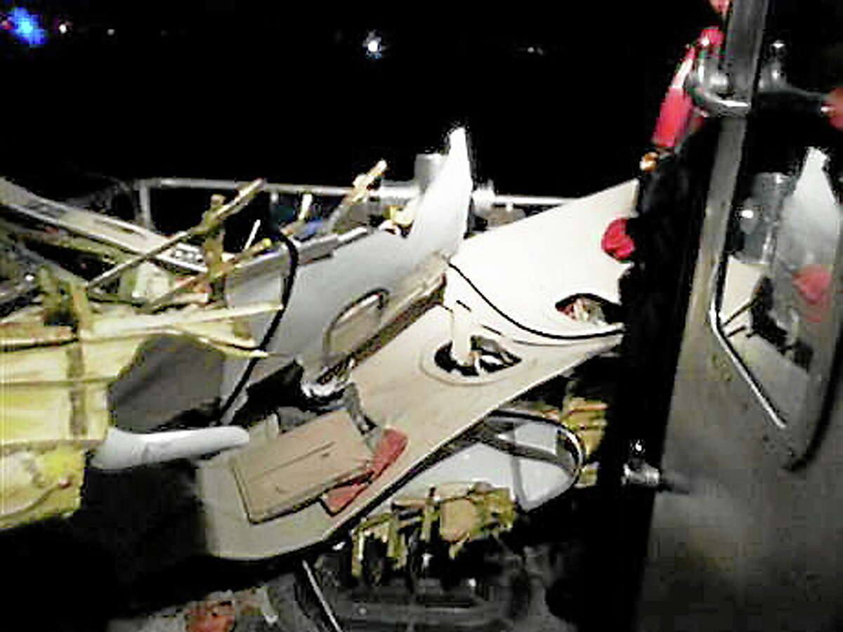 Wreckage of the plane that crashed off the coast of Fort Lauderdale, Fla., is brought aboard a Coast Guard boat Tuesday, Nov. 19, 2013, in Fort Lauderdale, Fla. Search and rescue crews from the Coast Guard, Florida Fish and Wildlife Conservation Commission and local police and fire rescue departments continue to search for possible survivors. (AP Photo/U.S. Coast Guard)