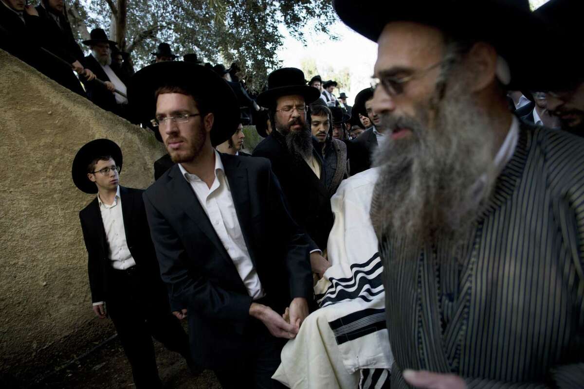 Ultra-Orthodox Jews carry the body of Mosheh Twersky during his funeral in Jerusalem, Tuesday, Nov. 18, 2014. (AP Photo/Oded Balilty)