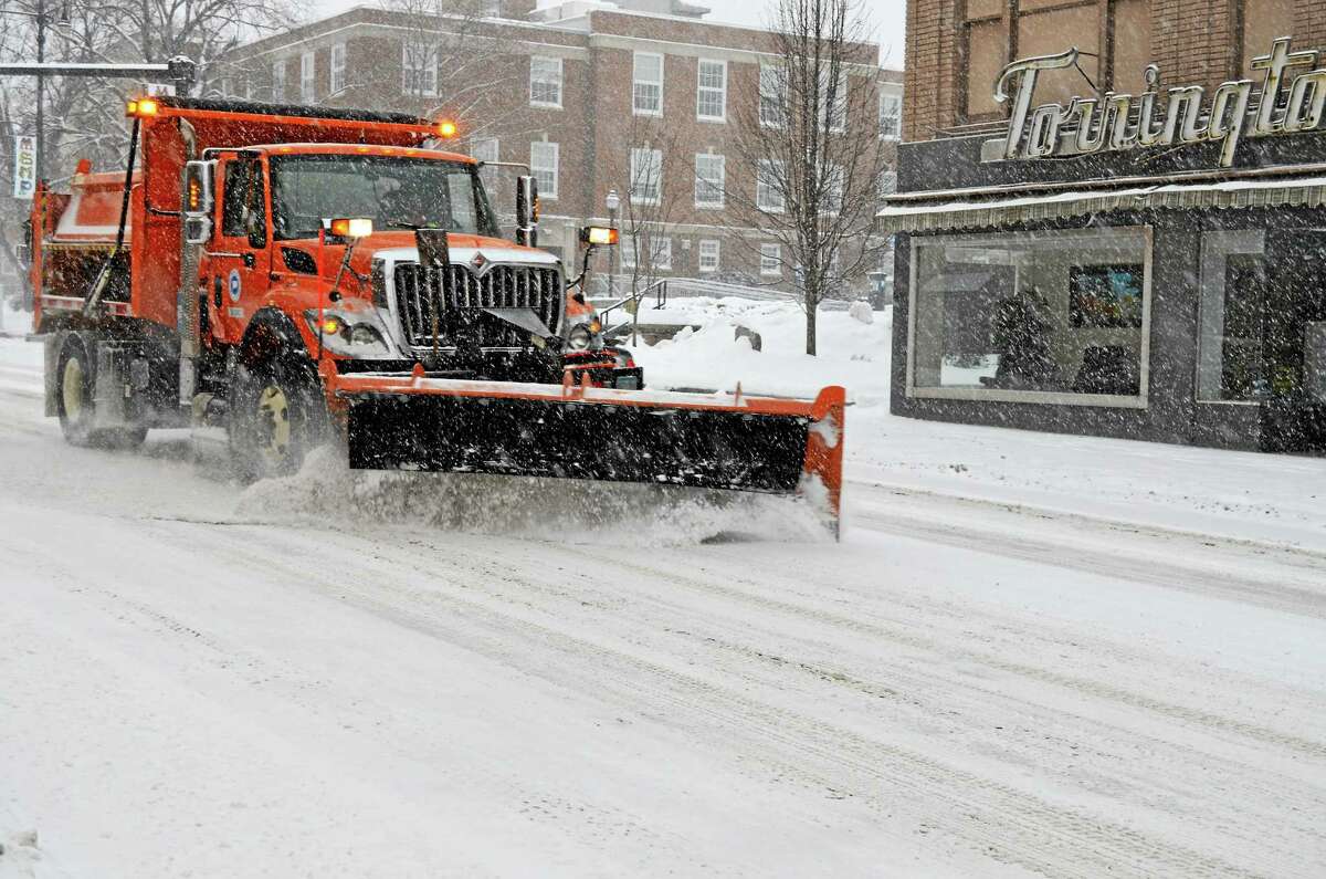 Kate Hartman-Register Citizen ¬ A plow removes snow from Main Street in Torrington early Thursday as another storm dropped more than 10 inches of snow throughout parts of Litchfield County.