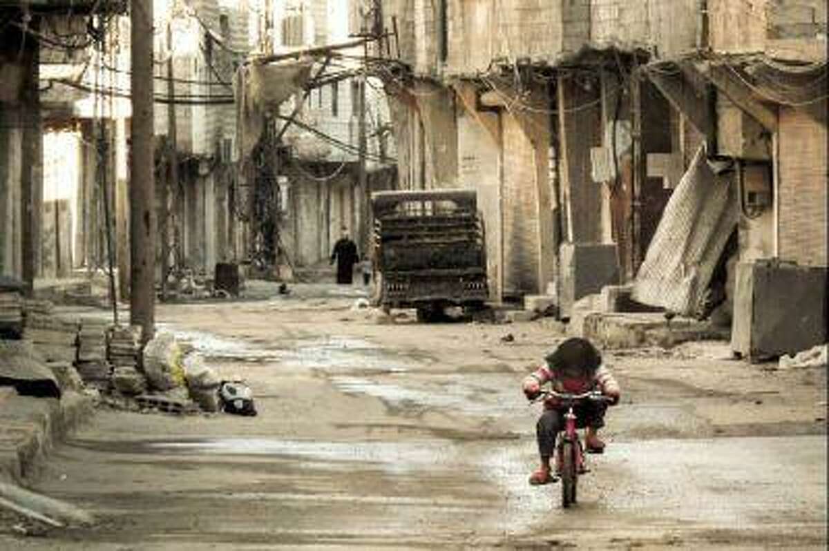 A Syrian girl rides her bicycle in an almost deserted street in the Teshrin neighborhood of Damascus on Jan. 3, 2013. According to Israeli military intelligence, the Syrian government has repeatedly used chemical weapons against the rebels fighting to overthrow it.