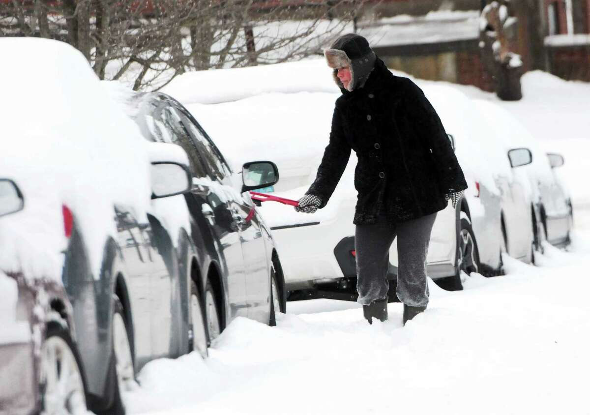 Laura Noe of Branford clears snow from her car Wednesday morning January 22, 2014, on Wilford Avenue in Branford.