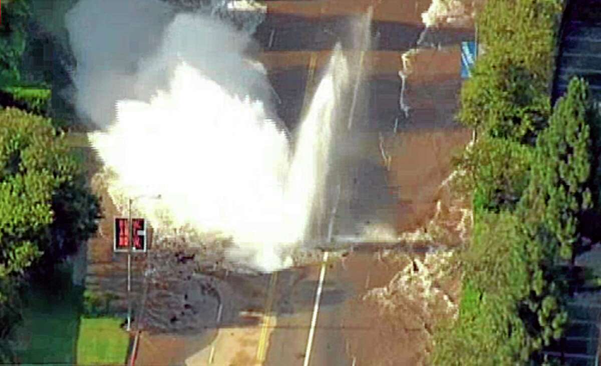 In this photo taken from video provided by nbc4la.com, water reaches into the air after a water main burst on Sunset Boulevard in Los Angeles near UCLA Tuesday, July 29, 2014. (AP Photo/nbc4la.com) MANDATORY CREDIT