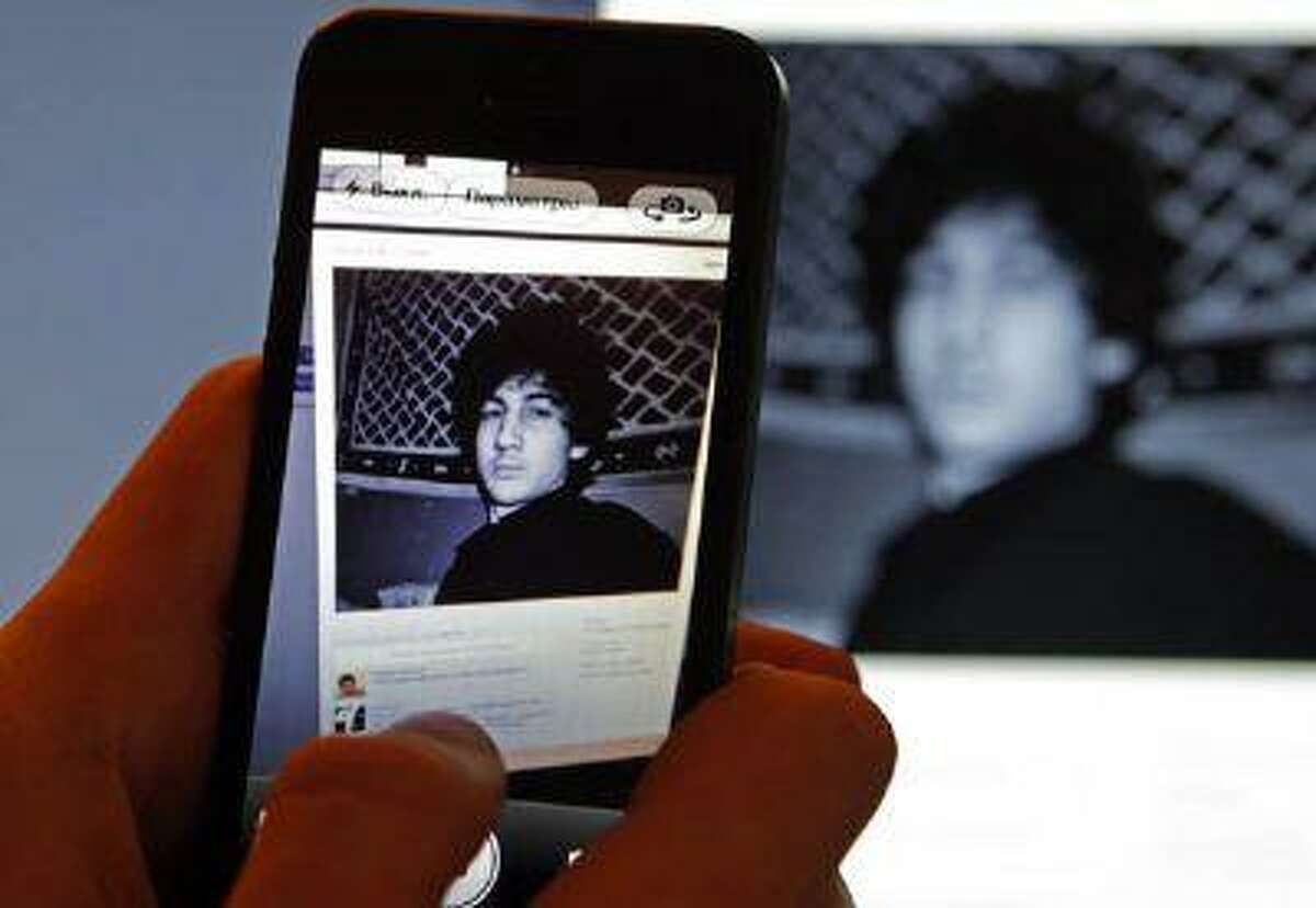 A photograph of Djohar Tsarnaev, who is believed to be Dzhokhar Tsarnaev, a suspect in the Boston Marathon bombing, is seen on his page of Russian social networking site Vkontakte (VK), as pictured on a monitor and a mobile phone in St. Petersburg April 19, 2013.