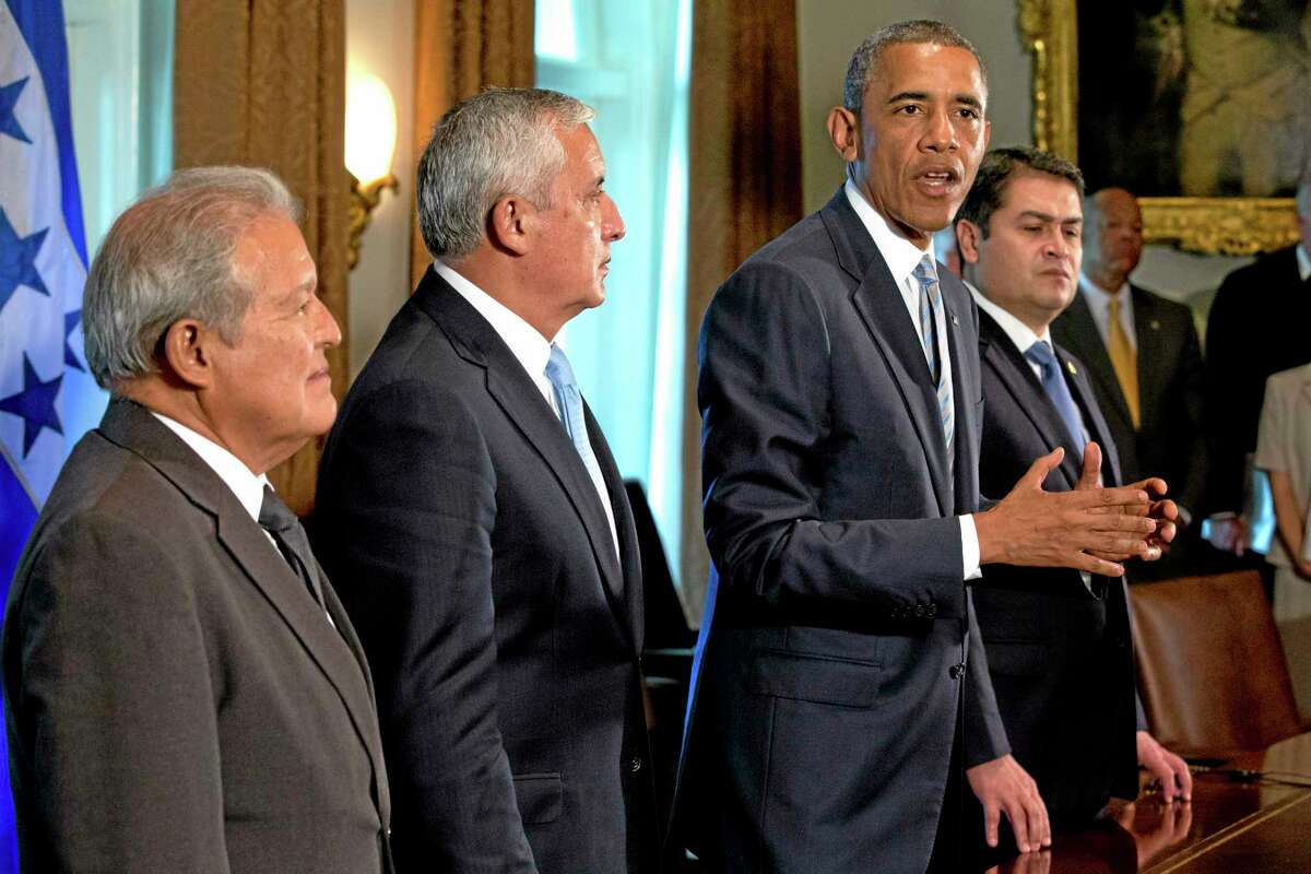 This July 25, 2014, photo shows El Salvador's President Salvador Sanchez Ceren, left, and Guatemala's President Otto Perez Molina, as they listen to U.S. President Barack Obama speaks to the media, next to Honduran President Juan Hernandez, right, after they met to discuss Central American immigration and the border crisis in the Cabinet Room of the White House in Washington. Even as they grapple with an immigration crisis at the border, White House officials are making plans to act before Novemberís mid-term elections to grant work permits to potentially millions of immigrants in this country illegally, allowing them to stay in the United States without threat of deportation, according to advocates and lawmakers in touch with the administration. (AP Photo)