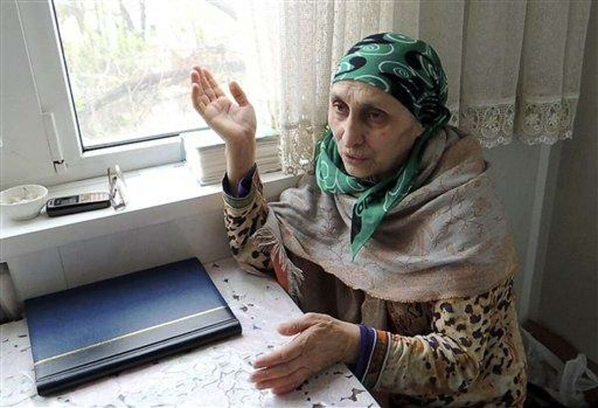 In this image taken from a video, Patimat Suleimanova, the aunt of USA Boston bomb suspects, speaks to The Associated Press in her home in the Russian city of Makhachkala, Monday April 22, 2013. Suleimanova says Tamerlan Tsarnaev struggled to find himself while trying to reconnect with his Chechen identity on a trip to Russia last year. He "seemed to be more American" than Chechen and "didn't fit into the Islamic world," she said.(AP Photo/AP Television)