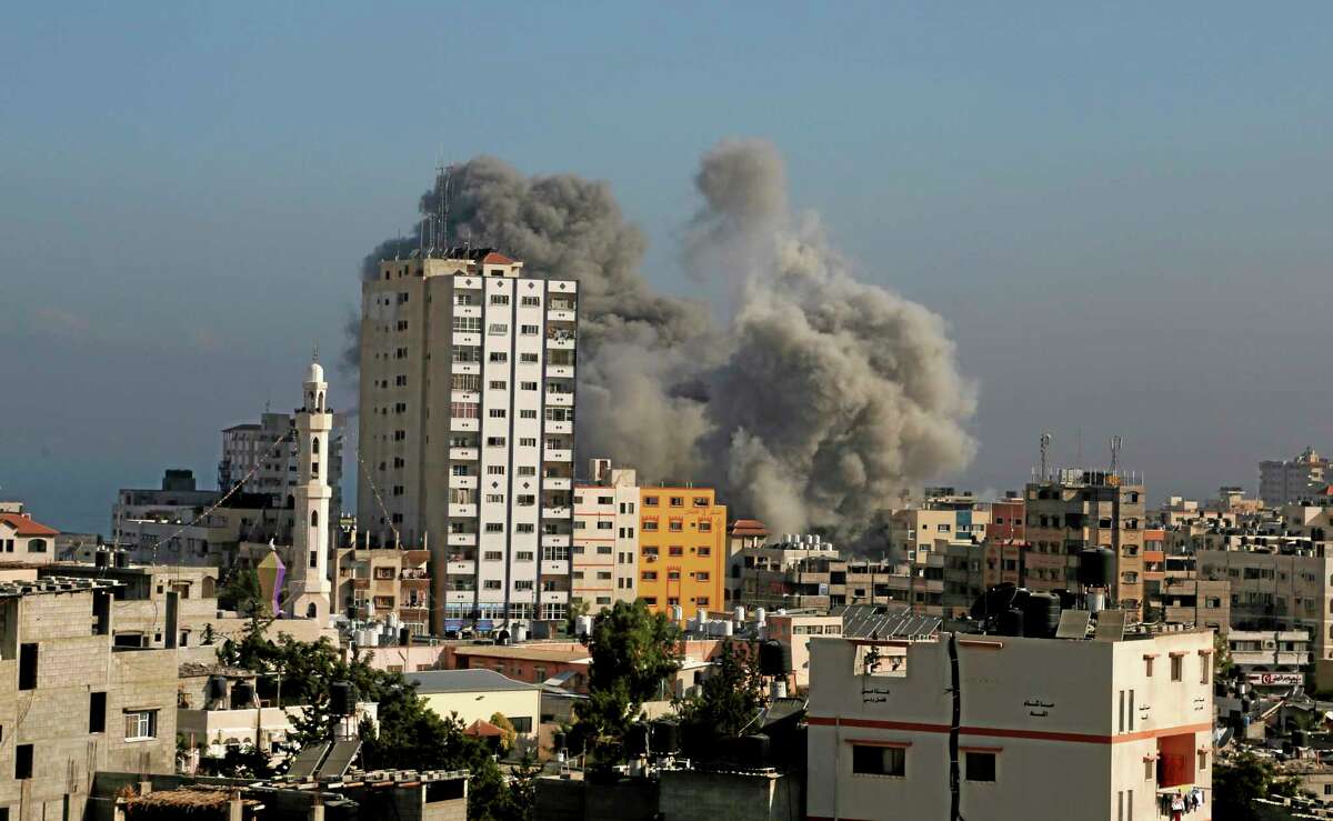 Smoke and fire from the explosion of an Israeli strike rise over Gaza City, Wednesday, July 30, 2014, amid Israel's heaviest air and artillery assault in more than three weeks of Israel-Hamas fighting. (AP Photo/Hatem Moussa)