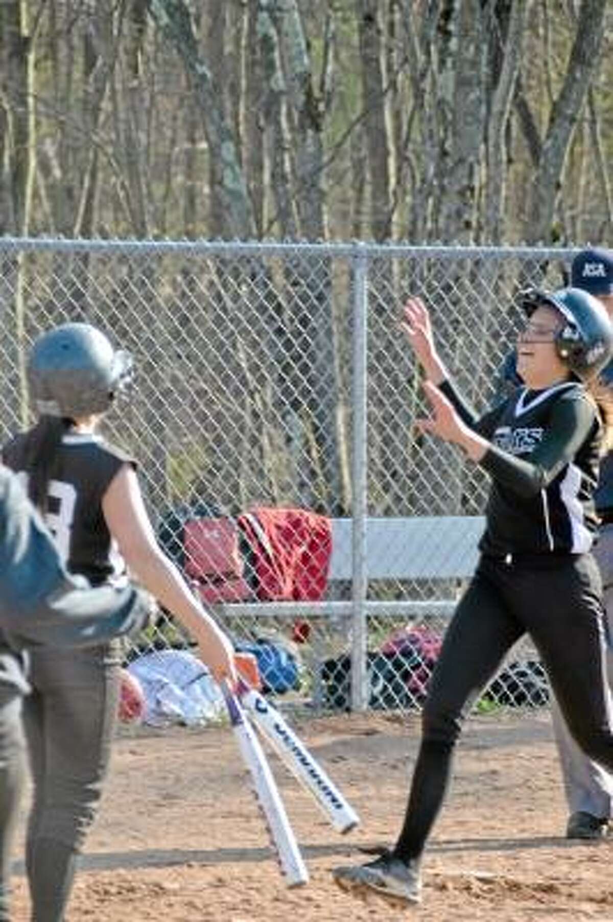 Pete Paguaga/Register Citizen Sophomore, Jill Donston is met at home plate by sophomore Nina Barone, after she hit a two-run homerun, in Thomaston's 11-6 win over Wamogo.