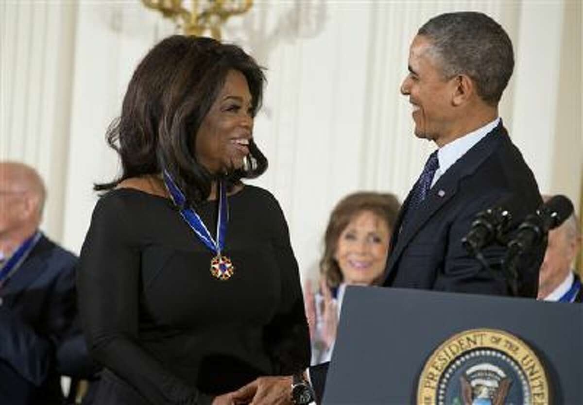 President Barack Obama smiles after awarding Oprah Winfrey the Presidential Medal of Freedom in the East Room of the White House on Wednesday, Nov. 20, 2013 in Washington. (AP Photo/ Evan Vucci)